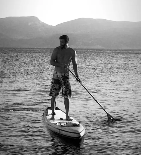 Enjoying stand up paddling at calm waters.