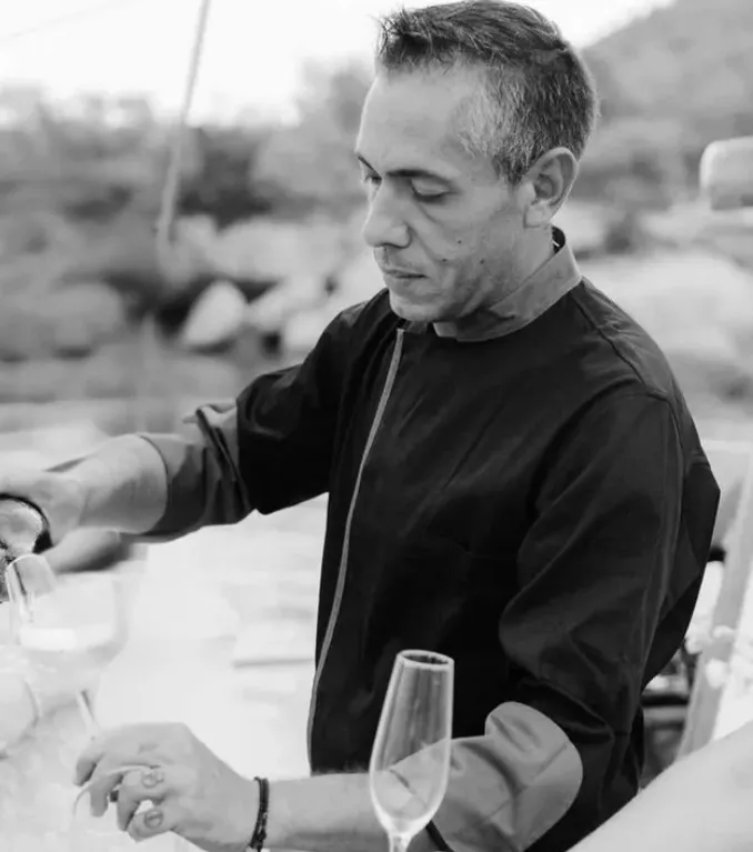 Chef serving wine onboard